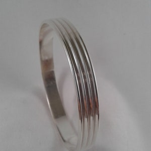 Wide ridged pattern sterling silver 9&quot; bangle bracelet.