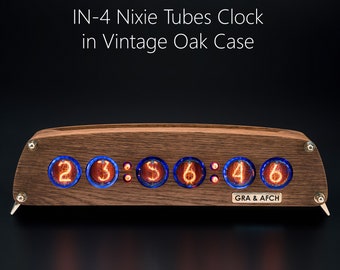 May include: A wooden clock with a vintage oak case and a display of six red Nixie tubes showing the time 23:56:46. The clock has a blue glass face and a metal frame. The clock is made by GRA & AFCH.