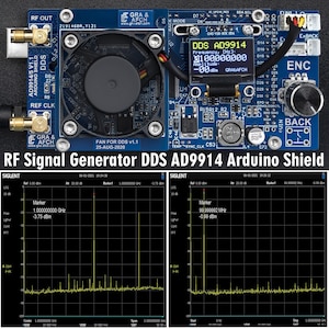 Könnte beinhalten: Eine blaue Arduino-Platine mit einem kleinen Lüfter, einem Display, das "DDS AD9914" anzeigt, und dem Text "Frequency, [Hz] 100,000,000 Amplitude: 00dBm GRAAFCH". Die Platine hat einen Drehknopf mit der Bezeichnung "ENC" und einen Knopf mit der Bezeichnung "BACK".
