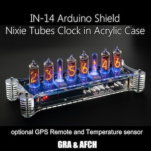 May include: A clear acrylic case houses a Nixie tube clock with an Arduino shield. The clock displays the time as 23:56:46. The clock is labelled "IN-14 Arduino Shield Nixie Tubes Clock in Acrylic Case".