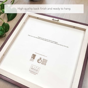 May include: The back of a wooden frame with a white background. The frame has a brown border and a hanging hook. The frame has a logo for City Wood and text that says "Thank you for all your time & dedication. Enjoy your next adventure & know that you've made a difference during this one."