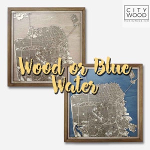 May include: Two framed wooden maps of San Francisco, one with a natural wood finish and the other with blue water. The text "Wood or Blue Water" is superimposed over the images.