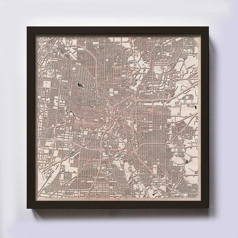 May include: A framed wood map of a city with a beige background and brown lines. The map is in a black frame.
