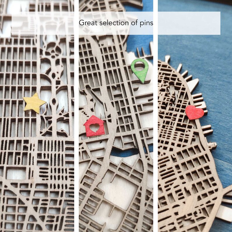 May include: A wooden map with a blue water feature and a variety of colored pins. The pins include a red house, a yellow star, a red heart, and a green location pin. The text "Great selection of pins" is visible at the top of the image.