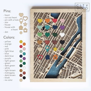 May include: A wooden map of a city with a key showing different colored pins and their meanings. The pins include a heart, a cut-out heart, a pin with a hole, a star, a house, a house with a heart, and a dot. The colors include yellow, orange, red, pink, light blue, blue, dark blue, purple, light green, green, dark green, white, light brown, mahogany, dark brown, black, and no color.