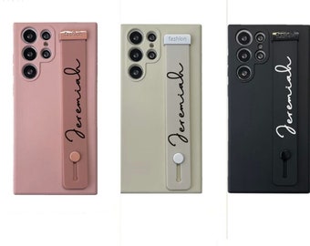 May include: Three phone cases with a personalized name "Jeremiah" printed on the strap. The cases are pink, beige, and black.