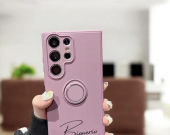 May include: A pink phone case with a ring holder and the word "Bionerio" written in cursive.