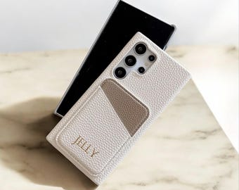 May include: White leather phone case with a card slot and the word "JELLY" embossed in gold lettering.