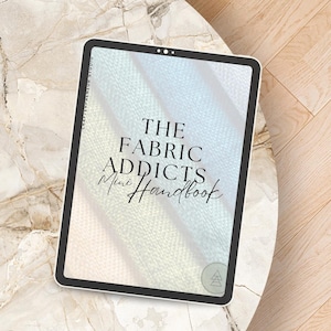 May include: A digital tablet shows the cover of "The Fabric Addicts Mini Handbook." The cover has a pastel colour gradient and the title in a bold, elegant font. The tablet is placed on a marble-effect surface.