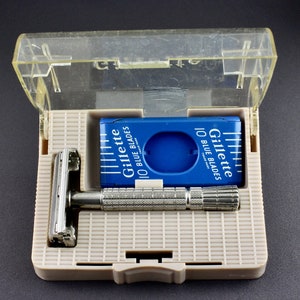May include: A silver razor with a blue and white Gillette 10 Blue Blades package in a clear plastic case.