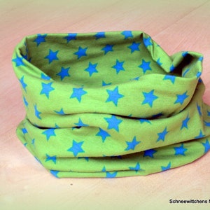 Könnte beinhalten: Ein grüner Stoff-Halswärmer mit einem blauen Sternenmuster.