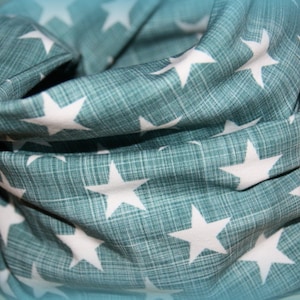 Könnte beinhalten: Ein türkisfarbener Stoff-Halswärmer mit einem weißen Sternenmuster.