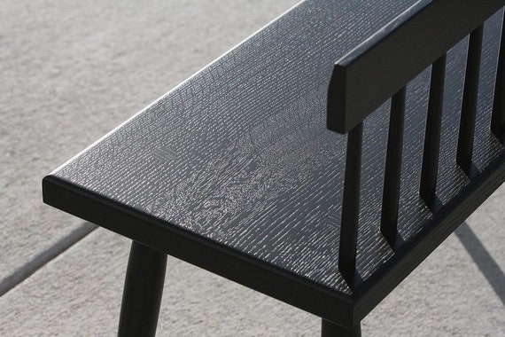 Small black bench with cheap back