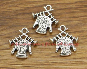 May include: Three silver charm pendants featuring a sweater hanging on a clothesline. Each charm has a detailed design of a sweater with a textured pattern.