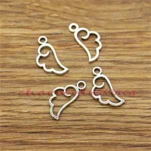May include: Four silver angel wing charms with a loop at the top for attaching to jewellery or other crafts.