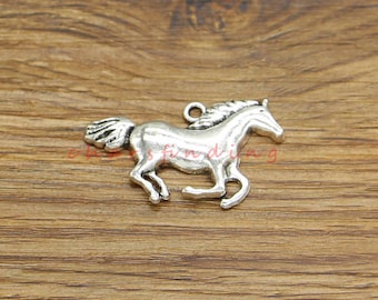 May include: Silver-toned metal charm of a horse running to the right. The charm has a loop at the top for attaching to a necklace or bracelet.