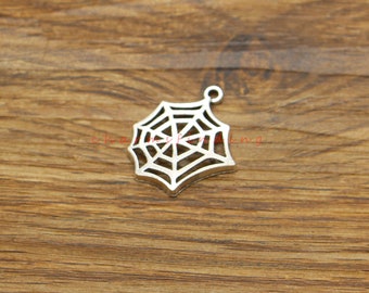 May include: Silver-toned metal charm shaped like a spider web. The charm has a loop at the top for attaching to a necklace or bracelet.