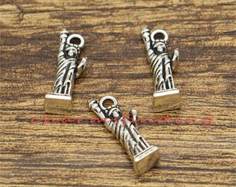 May include: Three silver-toned charms shaped like the Statue of Liberty. Each charm features a detailed design of the iconic landmark, including the torch, crown, and flowing robes. The charms are perfect for adding a touch of American history and patriotism to jewelry projects.