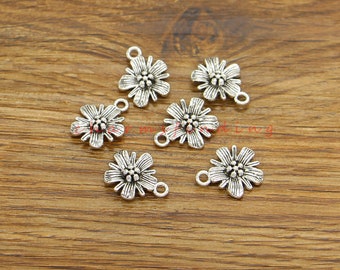 May include: Six silver-toned flower charms with a loop at the top for attaching to jewelry or other crafts.