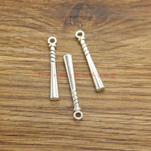 May include: Three silver baseball bat charms with a loop at the top for attaching to jewelry or other crafts.