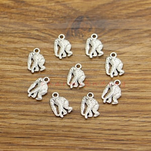 May include: Ten silver monkey charms with a detailed design. The charms are perfect for jewellery making, scrapbooking, and other craft projects.