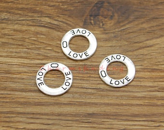 May include: Three silver-toned metal rings with the word "LOVE" engraved around the outside of each ring.