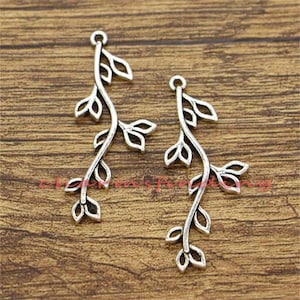 May include: Two silver-toned metal charms shaped like a vine with leaves. The charms are perfect for jewelry making or crafting.