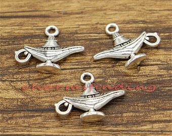 May include: Three silver-toned genie lamp charms with intricate details. The charms are ideal for jewellery making, scrapbooking, or other craft projects.