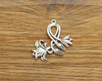 May include: Silver charm featuring a stylized lily flower design with a loop at the top for attaching to a necklace or bracelet.