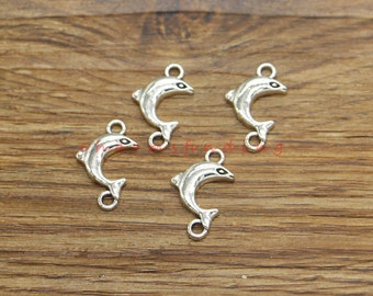 May include: Five silver dolphin charms with black eyes. Each charm has a loop at the top for attaching to jewelry or other crafts.