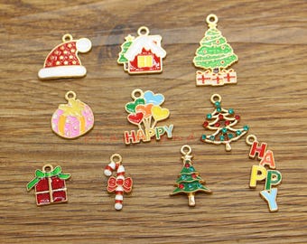 May include: Assortment of 12 gold-tone Christmas charm pendants. Charms include a Santa hat, a house, a Christmas tree, a candy cane, a gift box, a Christmas tree with ornaments, a Christmas tree with stars, a set of balloons with the word "HAPPY", and a set of letters spelling "HAPPY".