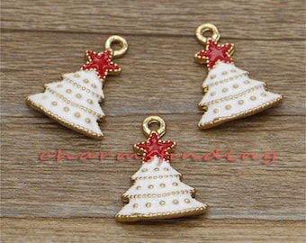 May include: Three gold-tone Christmas tree charms with white enamel and red star accents. The charms are perfect for adding a festive touch to jewelry, crafts, and other projects.
