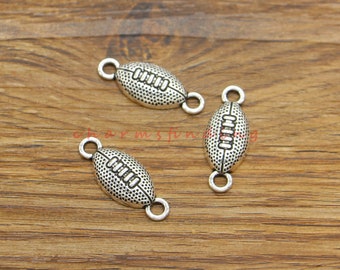 May include: Three silver-toned metal charms shaped like footballs with a textured surface. Each charm has two jump rings for attaching to jewelry or other crafts.