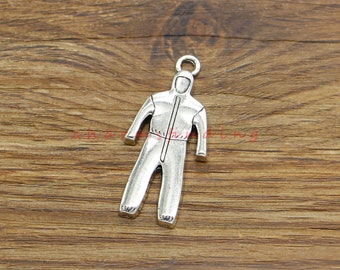 May include: Silver-toned charm in the shape of a hooded jumpsuit. The charm features a full-body design with a zipper down the front and a loop at the top for attaching to a necklace or bracelet. The charm is made of a metal alloy.