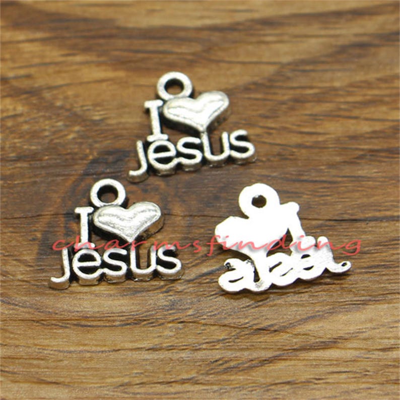 May include: Two silver charm pendants with the words "I love Jesus" and a heart. The charms are perfect for jewelry making or adding to a keychain.