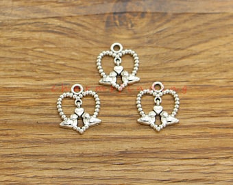May include: Three silver heart-shaped charms with a pair of birds inside each heart. The birds are facing each other and have a small heart between them.