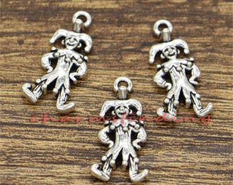 May include: Three silver charm pendants in the shape of a jester or clown figure. Each charm has a loop at the top for attaching to a necklace or bracelet.