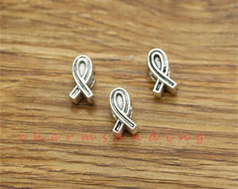 May include: Three silver charm beads in the shape of a ribbon. The ribbon is a symbol of support and awareness for various causes.