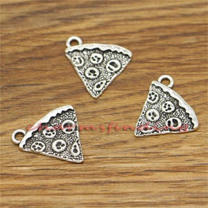 May include: Three silver-toned metal pizza slice charms with a detailed design. Each charm features a slice of pizza with pepperoni and cheese.