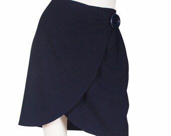 May include: A navy blue wrap skirt with a single large button at the waist.