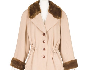 May include: A beige coat with a brown faux fur collar and cuffs. The coat has a button closure and a cinched waist.