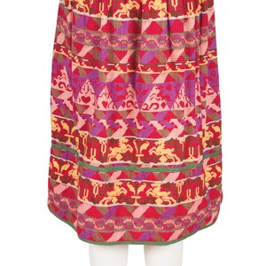 May include: A red, pink, purple, and yellow patterned skirt with a green waistband.