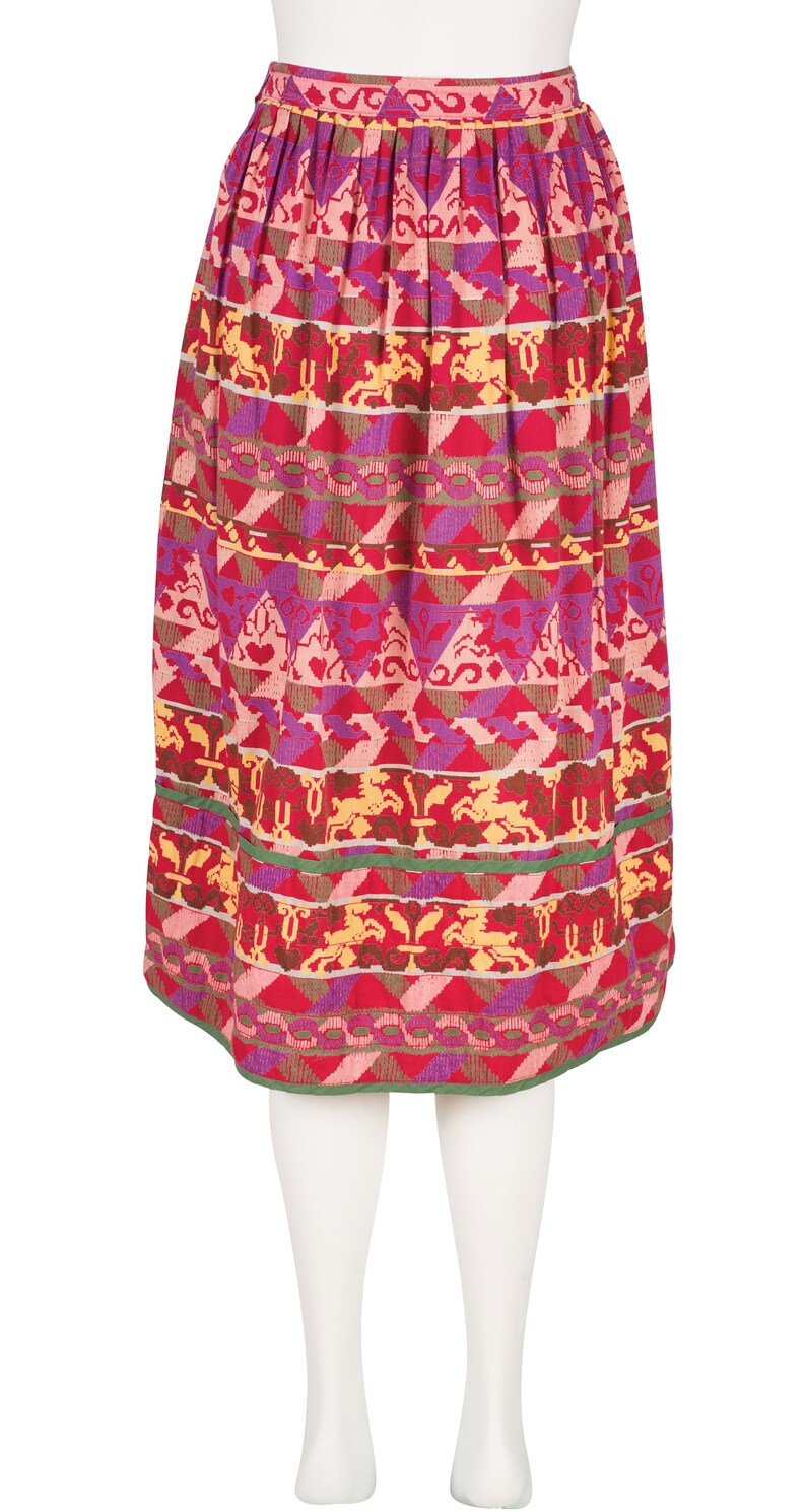 May include: A red, pink, purple, and yellow patterned skirt with a green waistband.