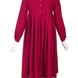 May include: A red and black gingham dress with long sleeves and a gathered skirt.