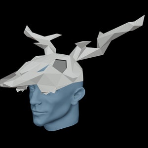 May include: A white papercraft deer mask with large antlers. The mask is made of folded paper and has a geometric design.