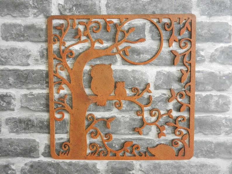 May include: Rustic metal wall art featuring an owl and two small animals perched on a tree branch with intricate leafy details. The metal has a rusty brown finish.