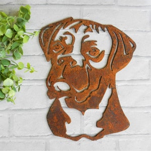 K&ouml;nnte beinhalten: Ein rostiger Metallausschnitt eines Boxerkopfes. Der Ausschnitt ist eine Silhouette des Hundekopfes und zeigt ein detailliertes Design des Hundekopfes.
