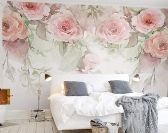 May include: A white bed with a gray blanket and a wicker basket at the foot of the bed. The wall behind the bed is decorated with a watercolor mural of pink roses.