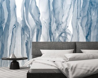 May include: A white bed with a gray headboard and white bedding. The wall behind the bed is decorated with a blue abstract painting.