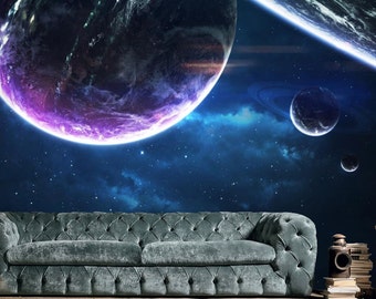 May include: A dark green velvet sofa with tufted buttons sits in front of a space-themed mural. The mural features a large planet with a purple ring, a smaller planet with a ring, and a starry background.